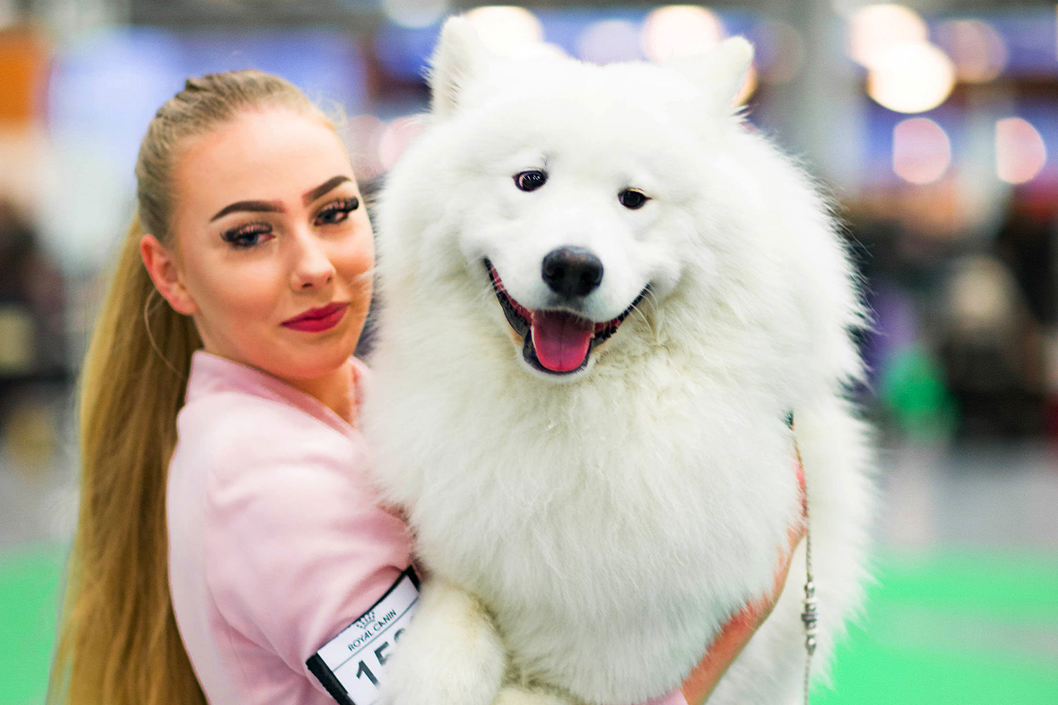 Proud handler carries her dog.